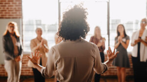 African american female empowering other colleagues in workplace