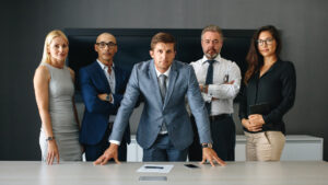 Business man standing with his corporate team in an office boardroom