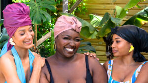 women wearing swimming caps smiling