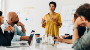 Business woman giving a speech in a boardroom meeting